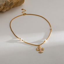 Carregar imagem no visualizador da galeria, Gold necklace with a cross pendant on a light background
